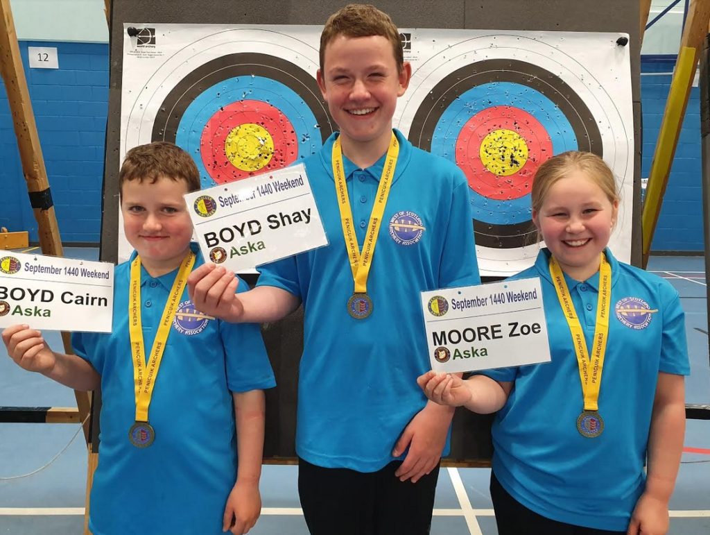 Cairn Boyd, Shay Boyd & Zoe Moore holding up the gold medals they won for winning their classes in the Penicuik 1440 shoot on the 8th September.